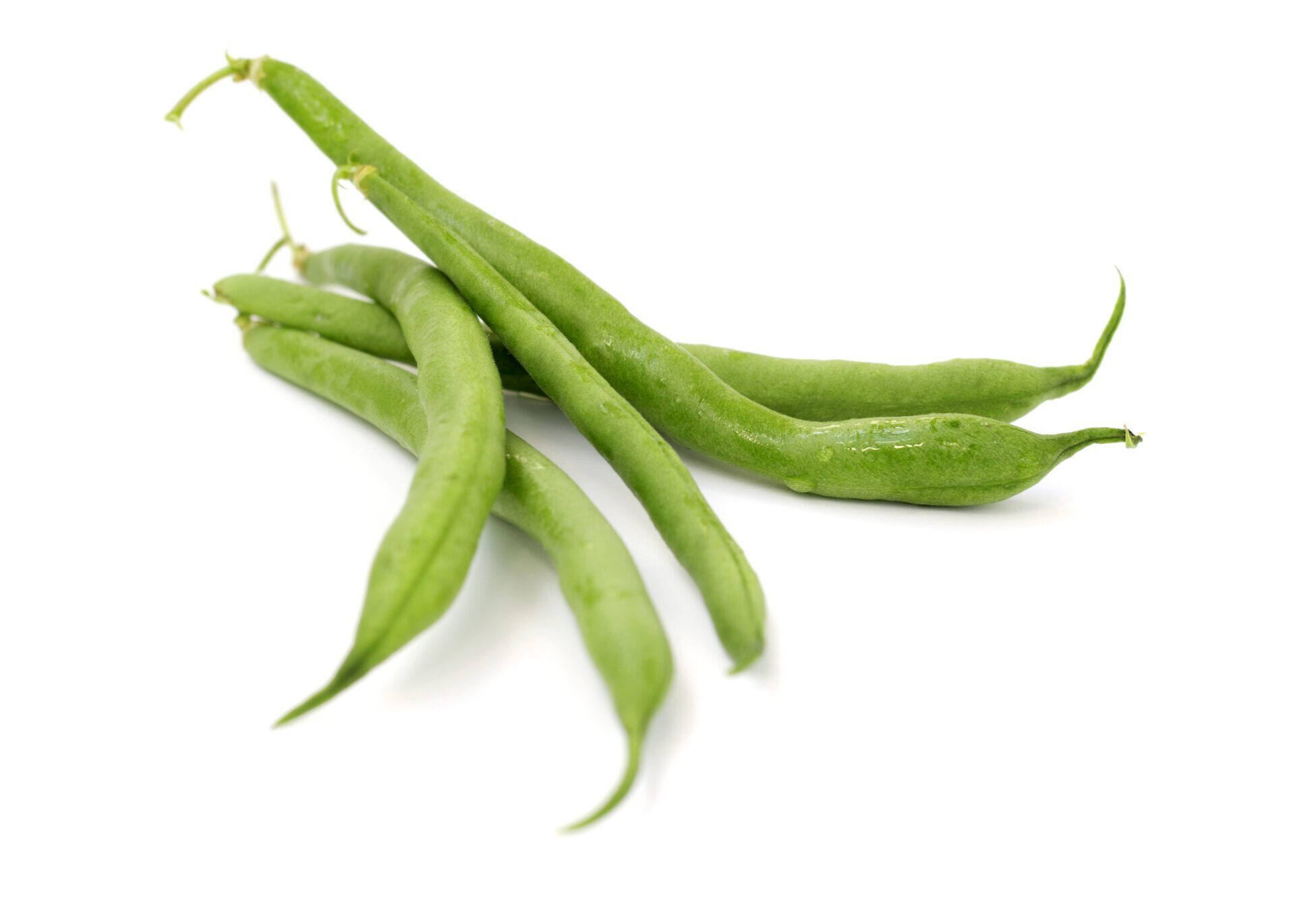 close up of green beans on white background